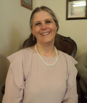 Dreama Lavina, Lead Developer and Technical Architect of Lavina Logos & Design, smiling in a professional portrait.
